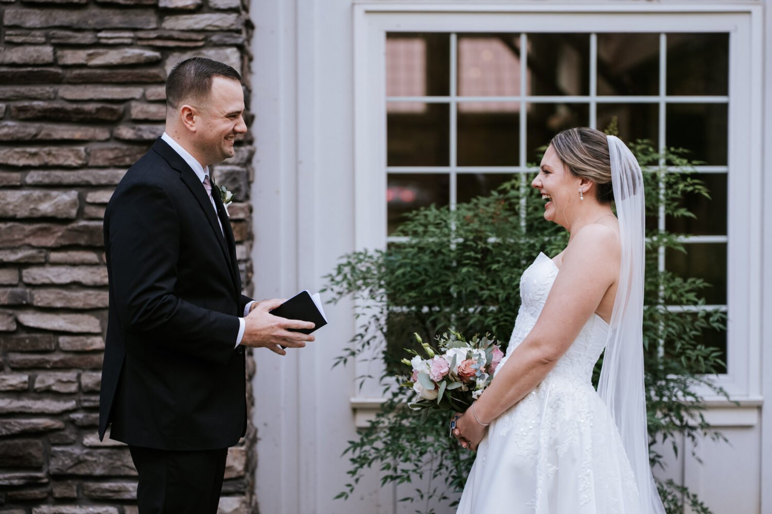 Bride and groom sharing a laugh during their private vow reading at Rosemont Springs
