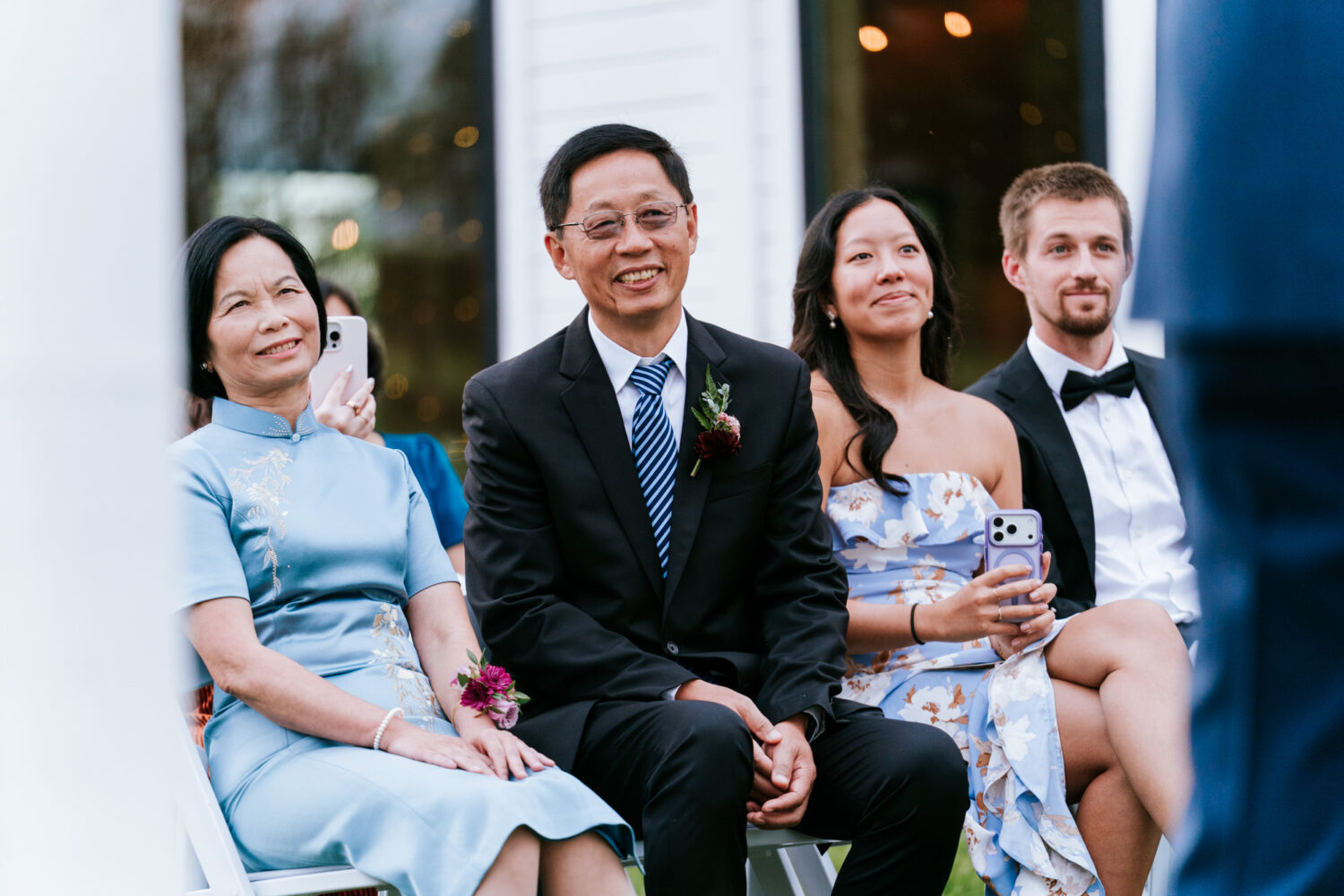 Guests seated and attentively watching the couple exchange vows
