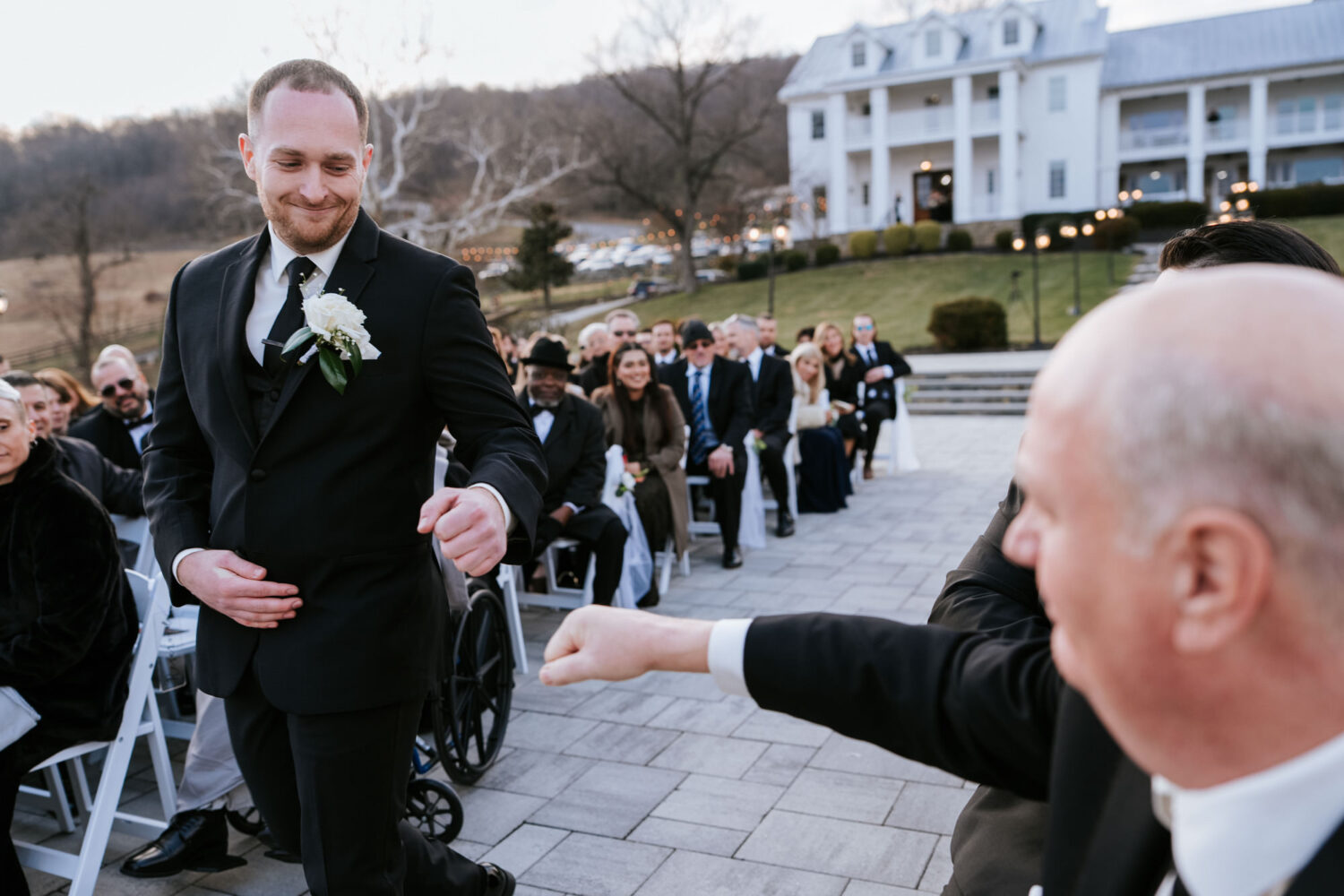 Groom fist bumping guest during ceremony at The View at Bluemont