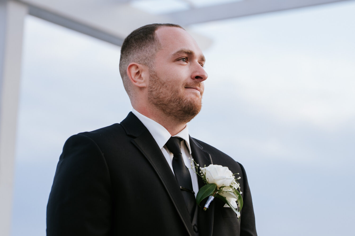Groom watching his bride walking dow the aisle during ceremony at The View at Bluemont wedding