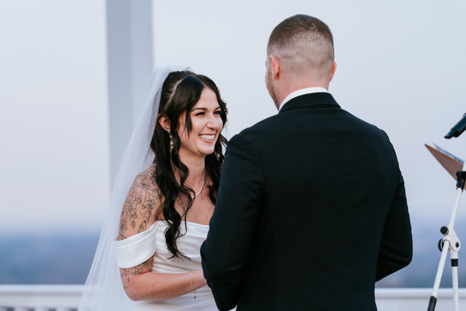 Bride laughing during outdoor wedding ceremony at The View at Bluemont with mountain views