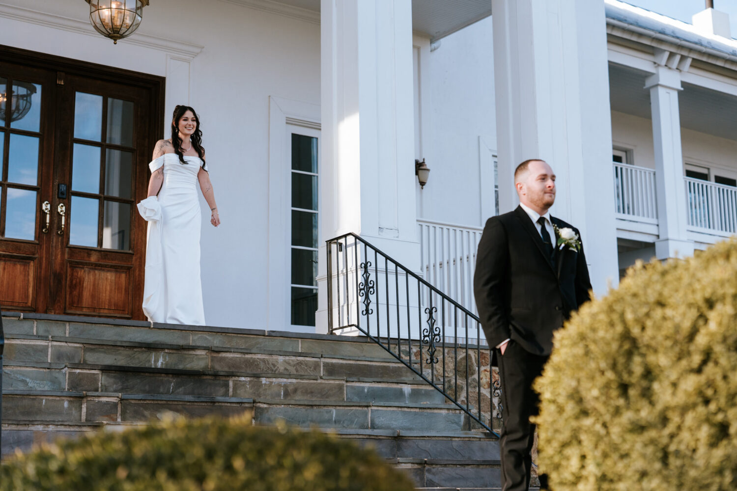 bride looking at groom before their first look on their wedding day